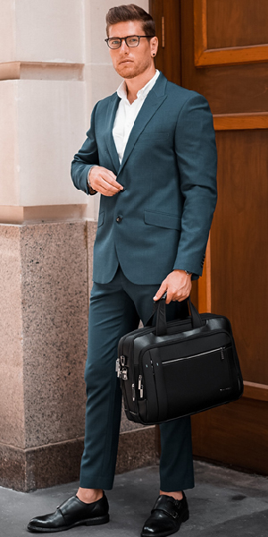 Business man in olive green suit with bag in hand